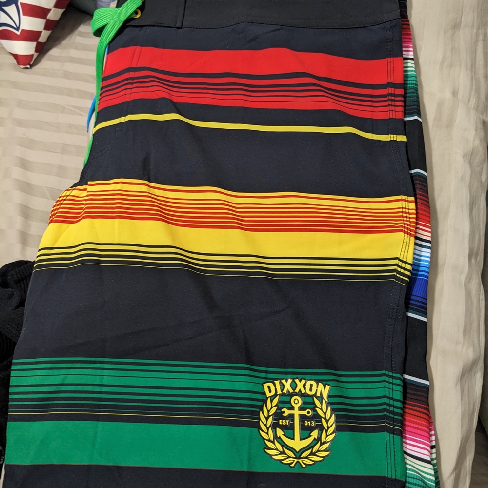 DIXXON Black Board Shorts with Red, Yellow, and Green Stripes